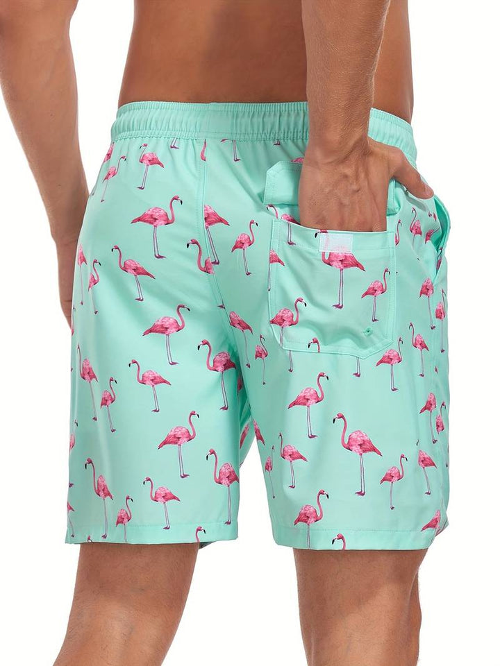Pantaloncini da bagno uomo verde menta con stampa fenicotteri rosa, tasca posteriore, elastico in vita. Costume mare estivo moda uomo.