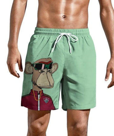 Pantaloncini da bagno verdi con stampa di scimmia stilizzata, occhiali da sole, giacca rossa. Moda uomo, costume mare estivo.