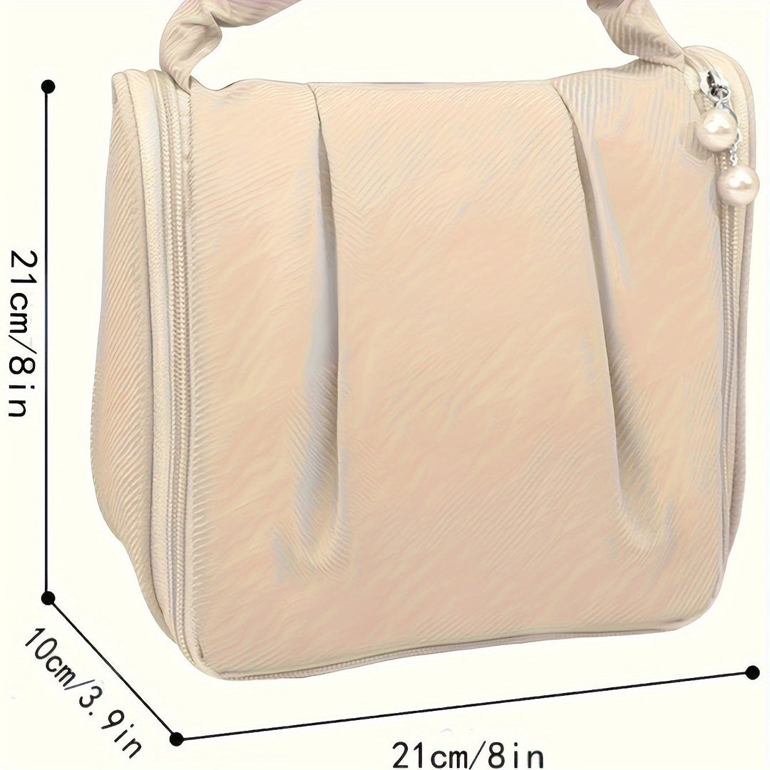 Borsa cosmetica beige con cerniera, dimensioni 21x21x10 cm, design elegante con perle decorative. Ideale per trucco e accessori da viaggio.