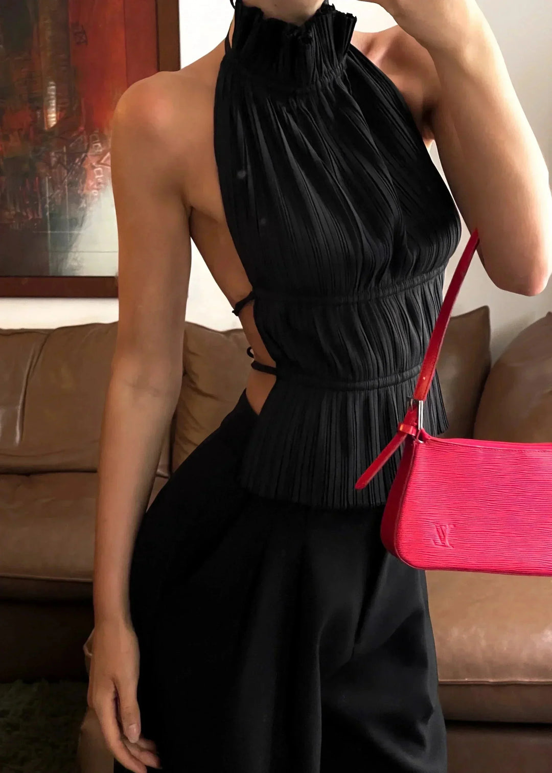 Haut femme dos-nu en tissu léger avec détails en chaîne métallique, idéal pour une tenue élégante et décontractée.