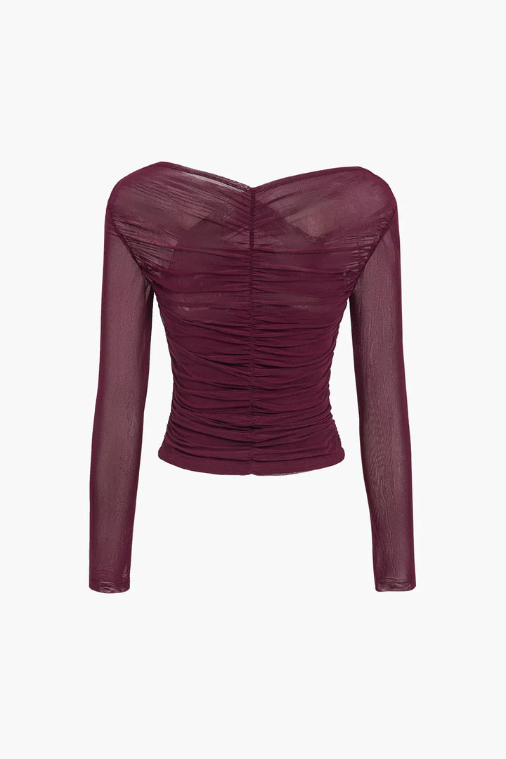Haut femme noir à manches longues, transparentes et plissées, en tissu léger.