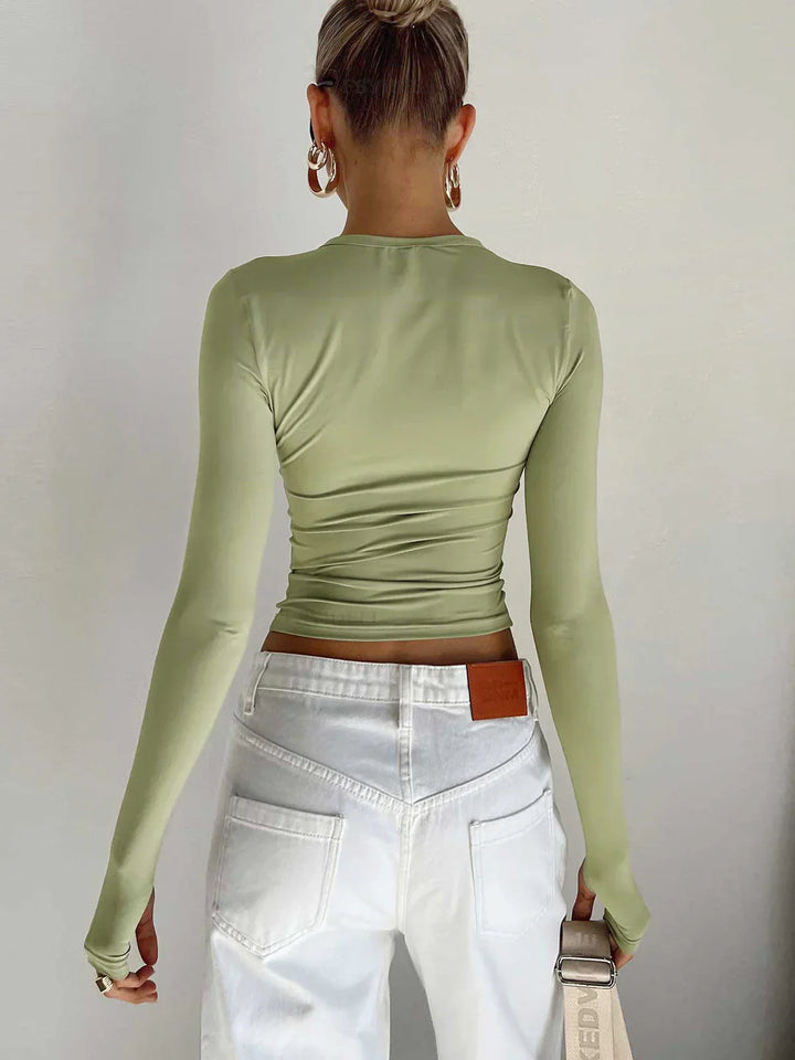 Haut femme à manches longues en tissu extensible, coupe ajustée, couleur vert clair, idéale pour le quotidien.