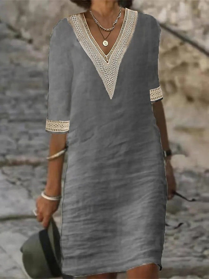 Abito estivo grigio da donna con scollo a V e dettagli in pizzo, maniche a tre quarti, perfetto per look casual eleganti.