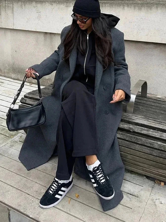 Manteau d'hiver femme noir, coupe oversize, en matériau chaud, avec poches pratiques et design moderne.