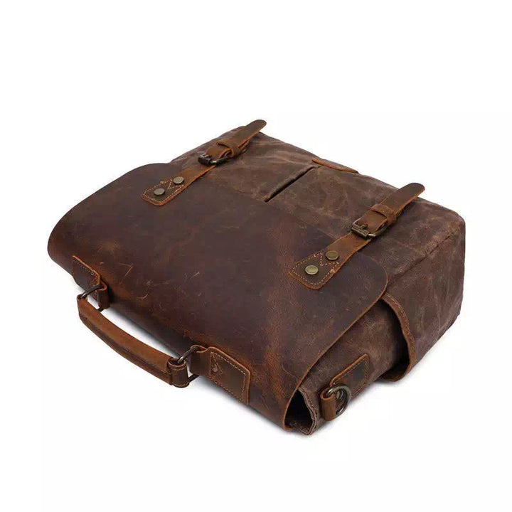 Borsa messenger in pelle marrone vintage, design elegante con fibbie e manico robusto. Ideale per lavoro e viaggio. Accessorio moda uomo.