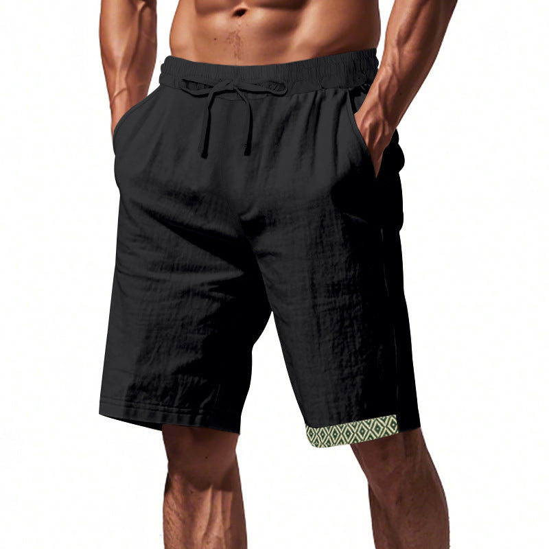 Pantaloncini uomo neri con elastico in vita e tasche, dettagli geometrici verdi sull&