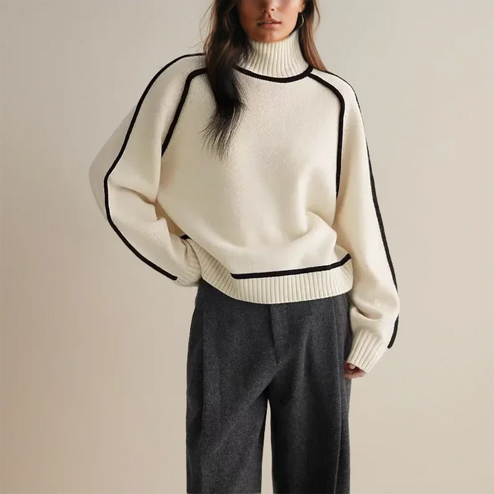 Pull col roulé femme en brun, avec bordure contrastée et coupe ajustée.