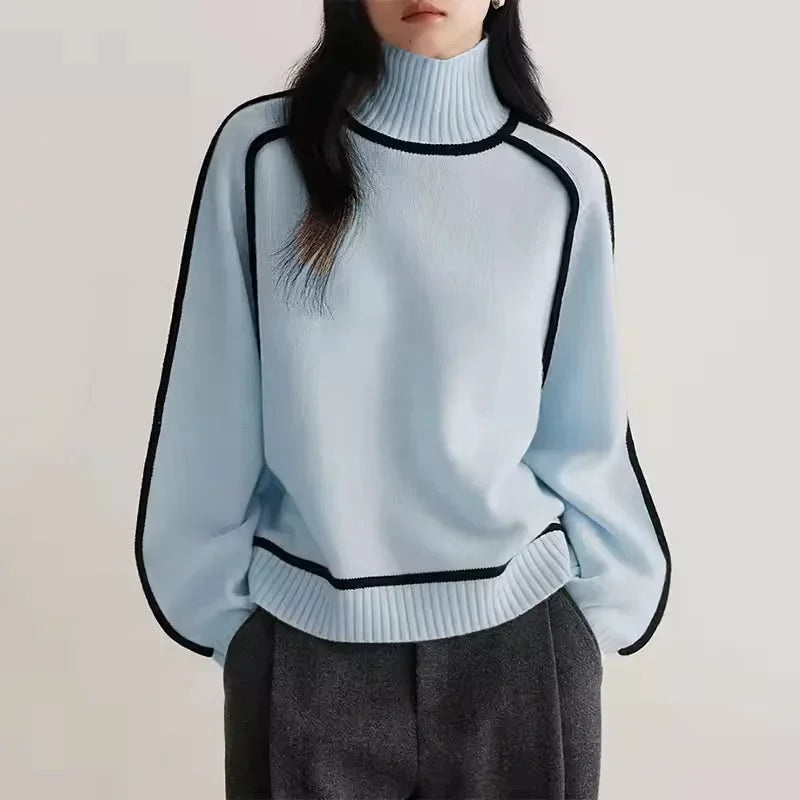 Pull col roulé femme beige en matière douce, avec bordure contrastée pour un style moderne.