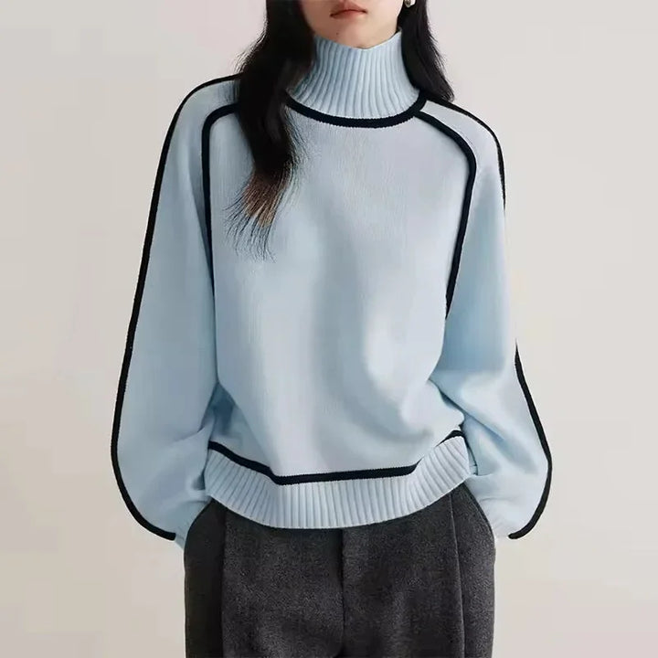 Pull col roulé femme beige en matière douce, avec bordure contrastée pour un style moderne.