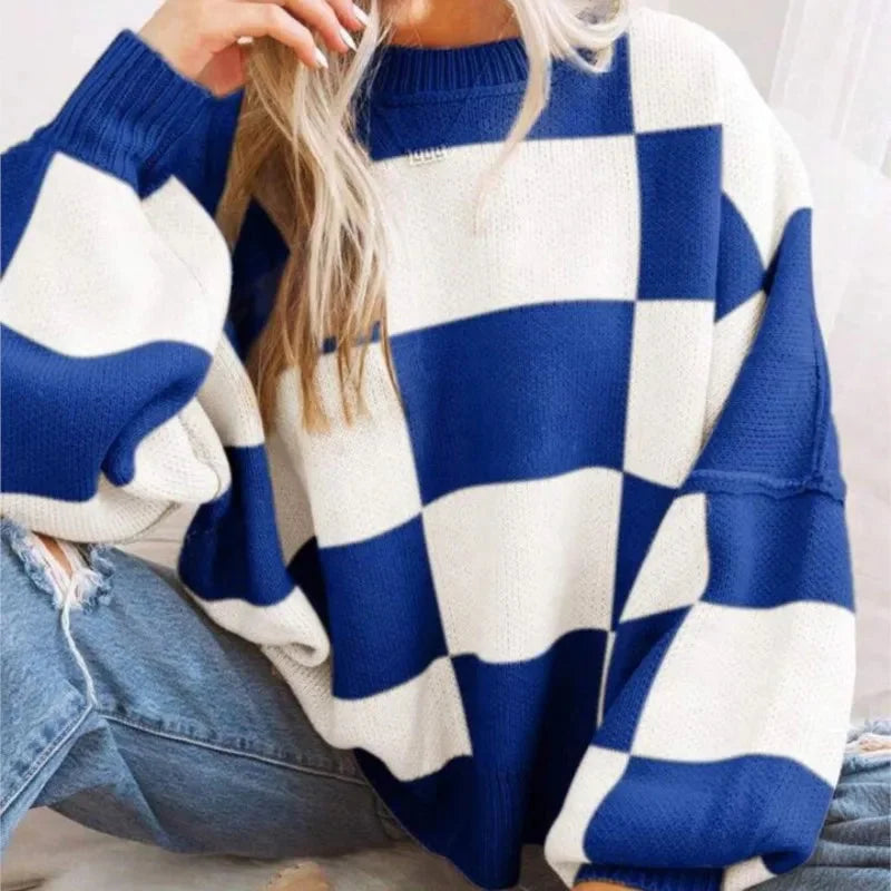 Pull femme orange en maille douce, à carreaux, avec un design décontracté, adapté pour un usage quotidien.