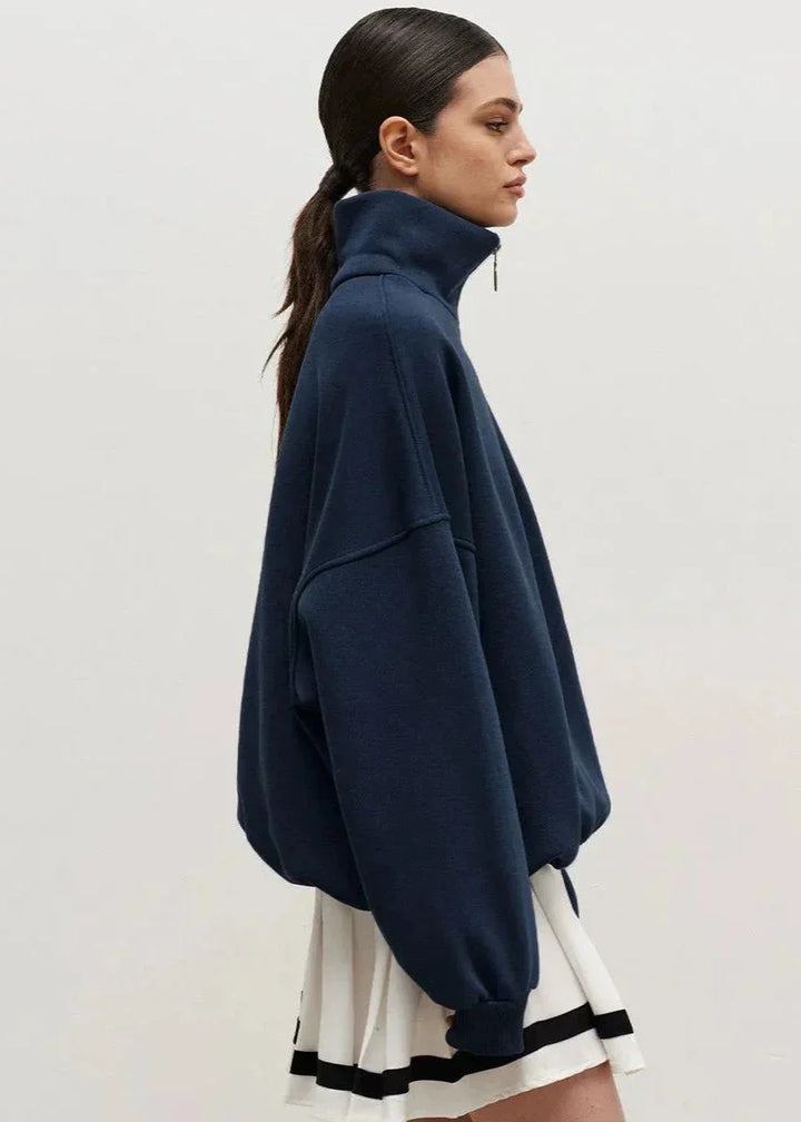 Pull à fermeture éclair bleu marine, coupe décontractée, tissu doux pour un confort optimal.
