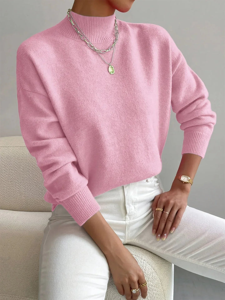 Pull blanc féminin col montant, en tissu extensible, à manches longues et coupe simple.