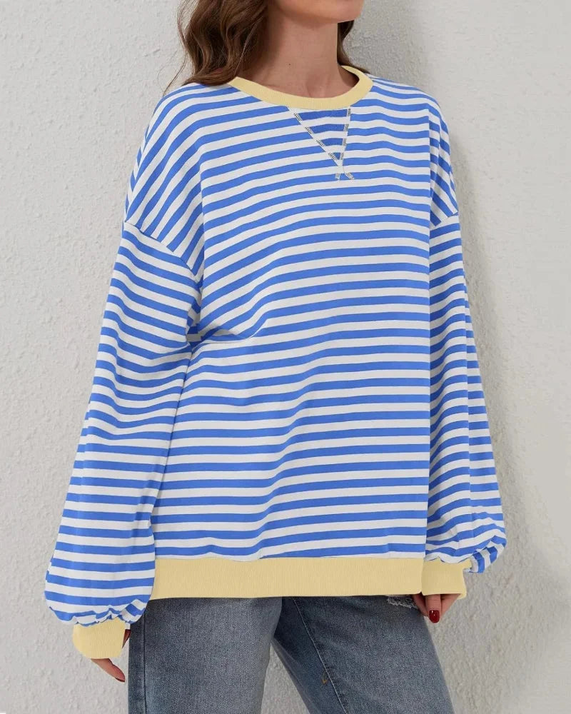 Pull oversize rayé rose en coton, conçu pour un style décontracté et des occasions informelles.