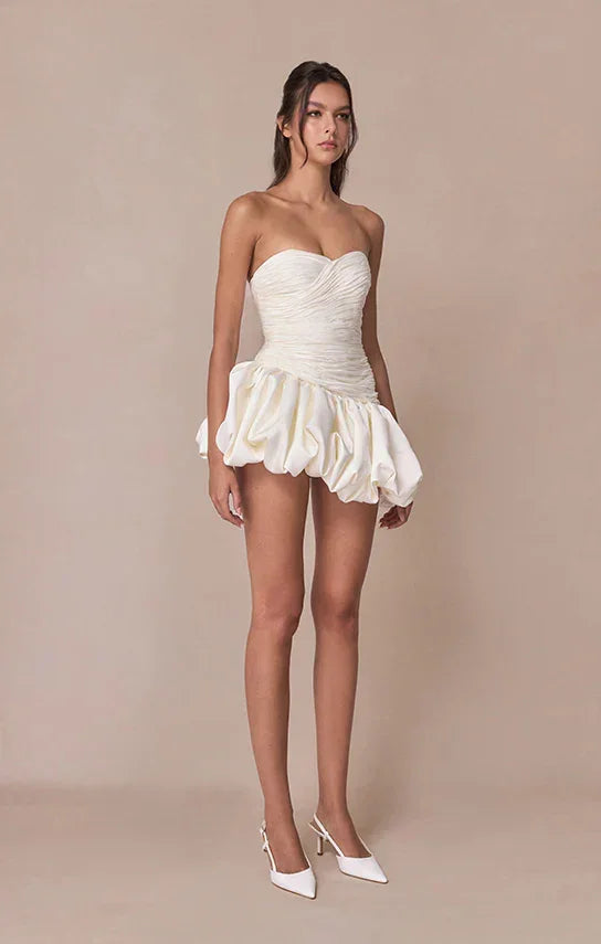 Robe de soirée femme en tissu drapé, style ballon, avec manches délicates et ceinture accentuant la taille.