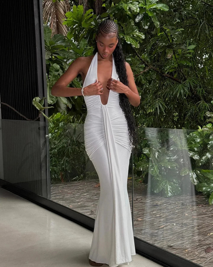 Robe d'été blanche pour femme, encolure plongeante et dos nu, confectionnée en coton léger et fluide pour un confort estival.