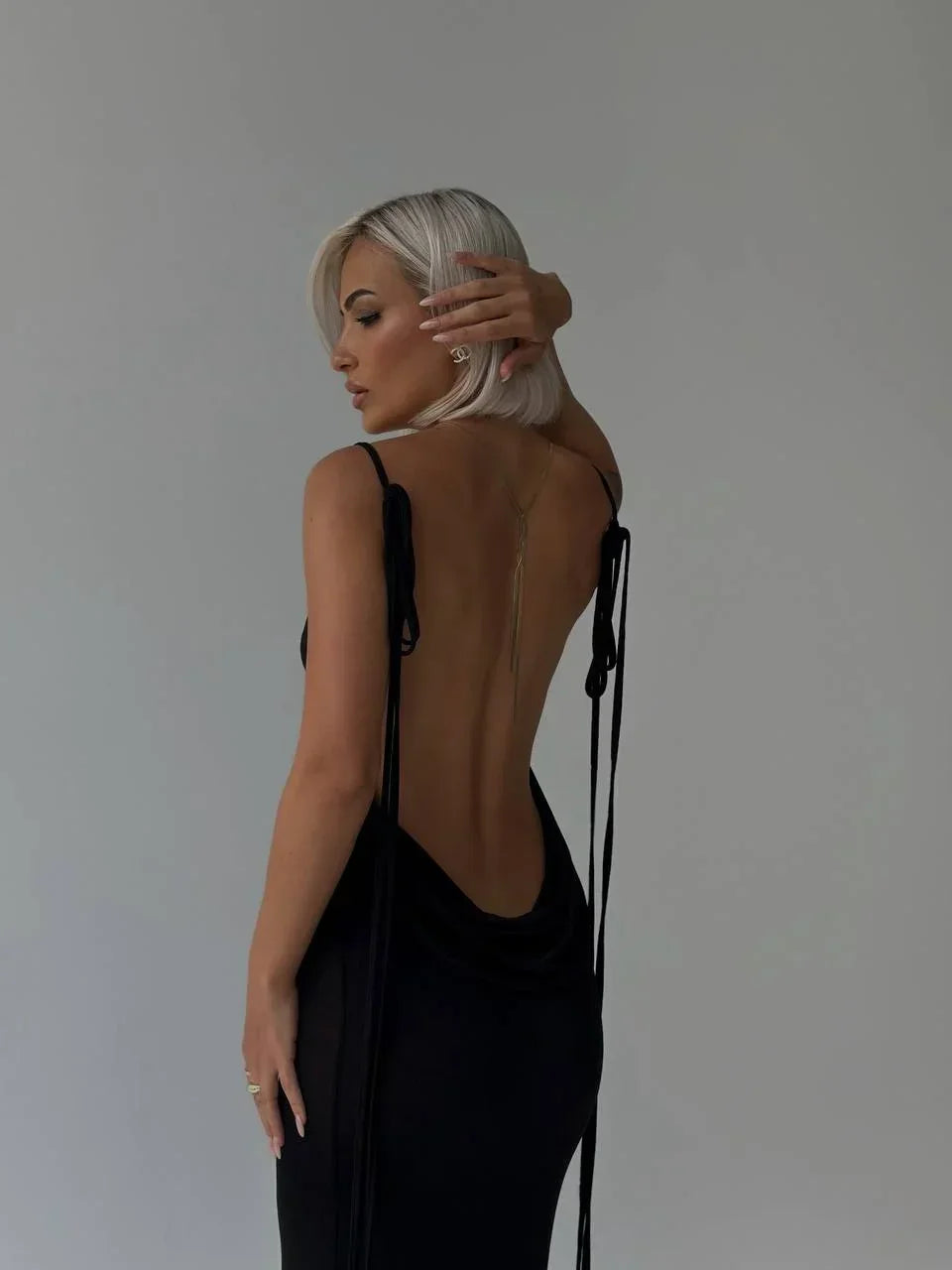 Robe longue dos nu ajustable avec liens en tissu léger, parfaite pour les soirées d'été, avec un design fluide et élégant.