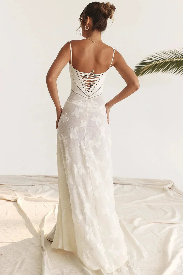 Robe longue en dentelle florale avec fines bretelles, coupe ajustée, tissu léger et motifs délicats.