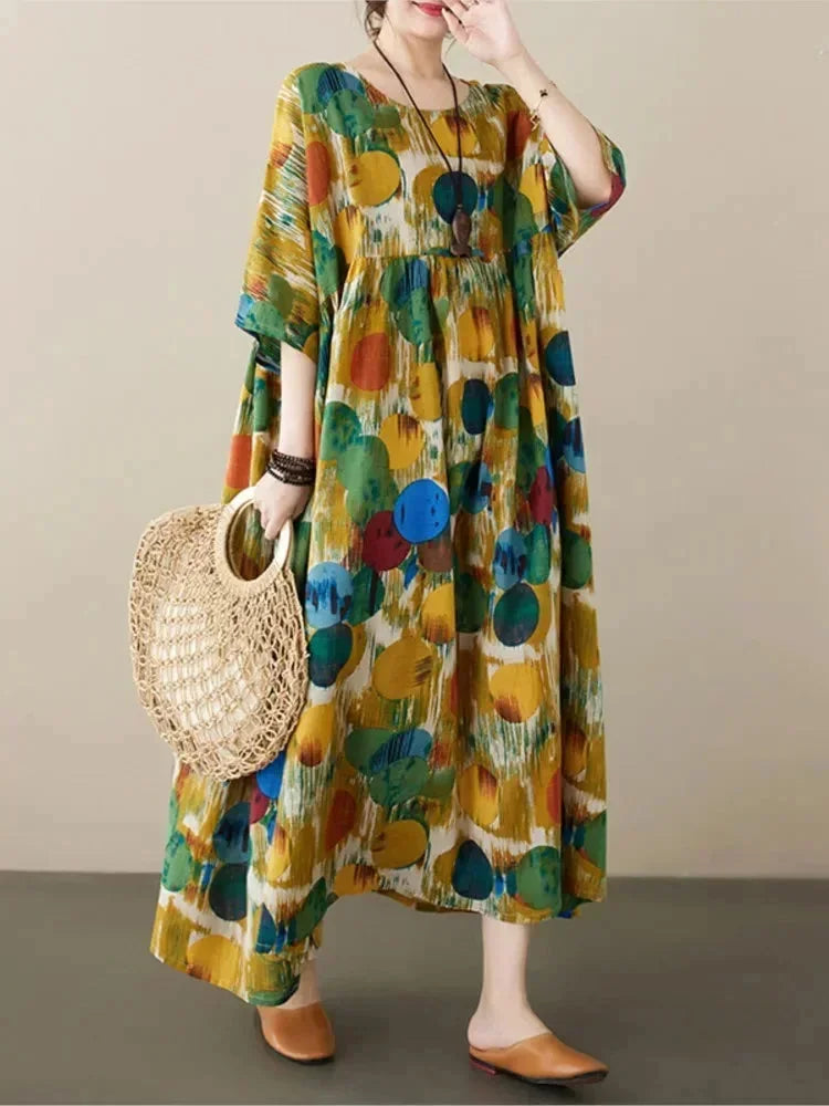 Robe longue en coton, ample, avec imprimé artistique coloré et manches mi-longues pour un look décontracté et élégant.