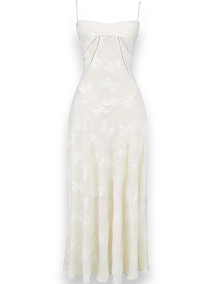 "Robe longue en coton léger avec broderie florale délicate et bretelles fines, parfaite pour les journées d'été."