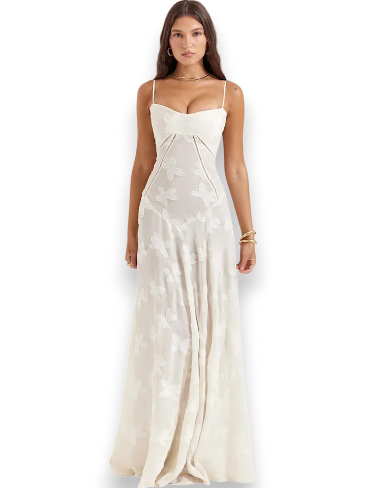 Robe longue blanche avec broderie florale délicate et bretelles fines, en coton léger pour un confort optimal.