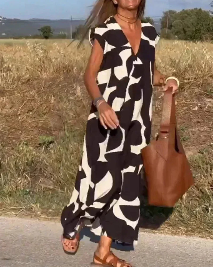 Robe longue femme en tissu léger, col V, avec motifs fluides pour un look élégant et décontracté.