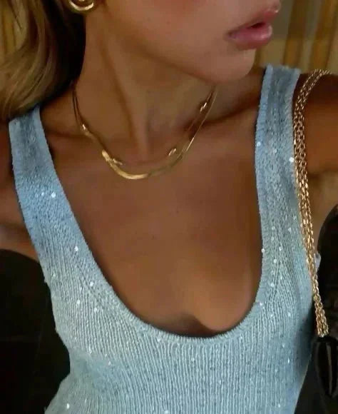 Robe longue sans manches en tissu bleu glacé, ajustée à la taille, parfaite pour les occasions estivales.