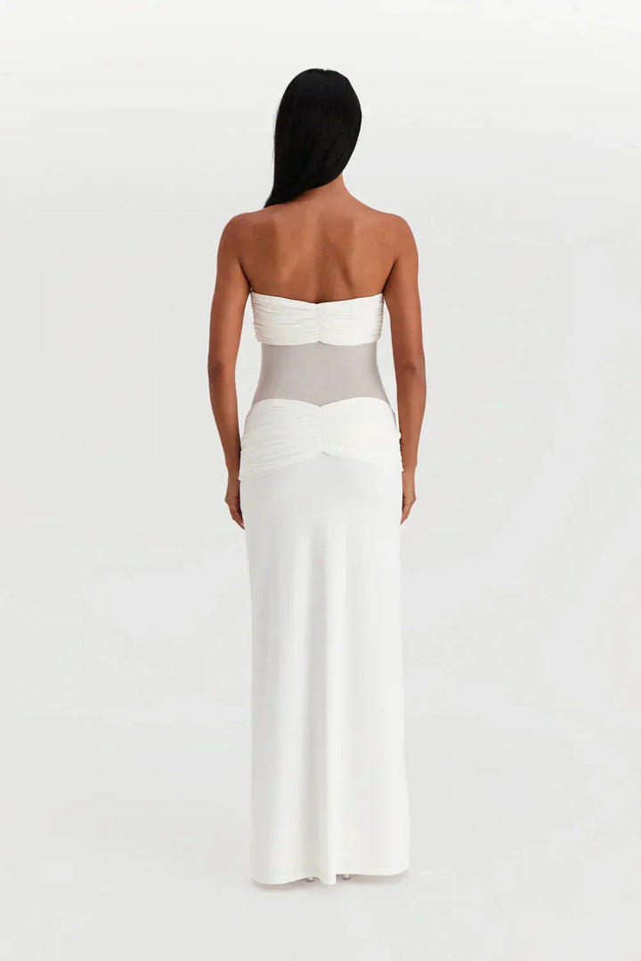 Robe longue femme en tissu fluide, bustier ajusté avec détail transparent et nœud à la taille pour un look élégant.