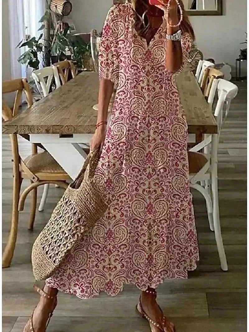 Robe longue rose pour femme, col en V, en tissu léger avec motifs floraux délicats et coupe fluide pour un style élégant.