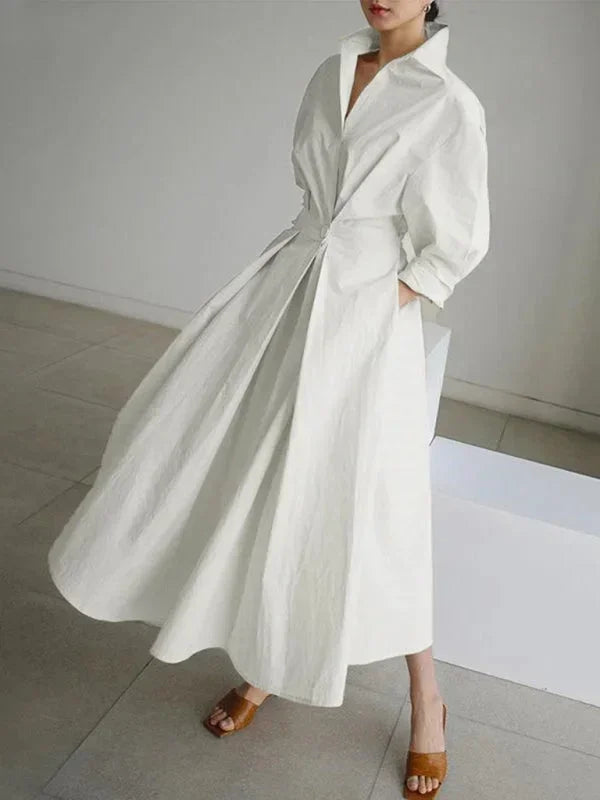 Robe longue femme en tissu léger, col fluide et manches, dotée de poches pratiques pour un style confortable et décontracté.