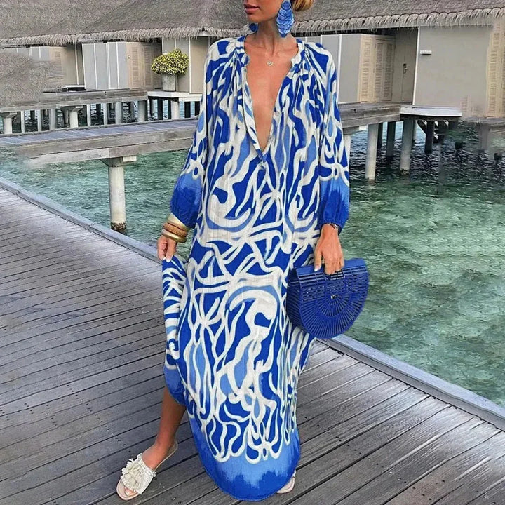Robe longue en polyester bleu, manches longues, col V, imprimé floral, idéale pour des occasions décontractées.