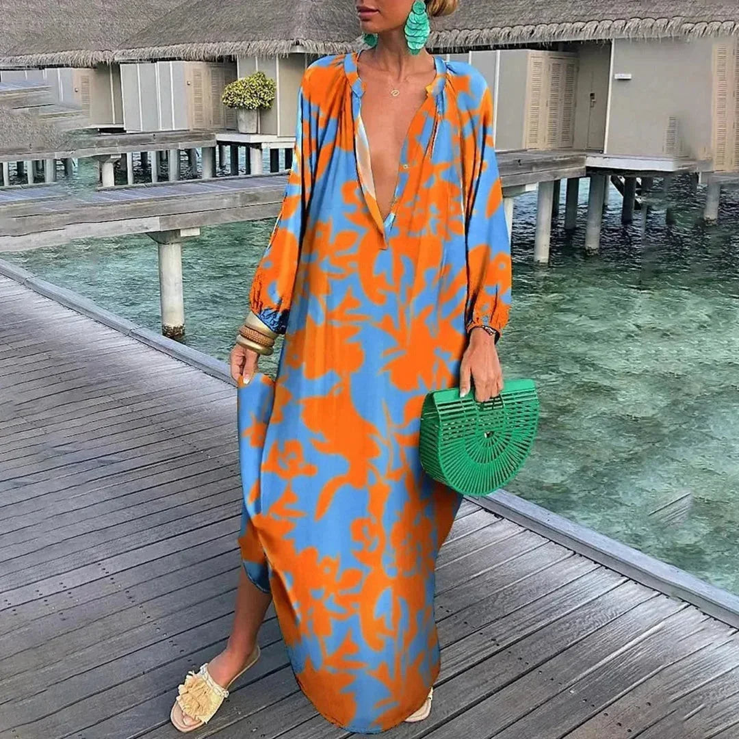 Robe longue en orange, imprimée, avec manches longues et col V, conçue en tissu léger et fluide pour un confort optimal.
