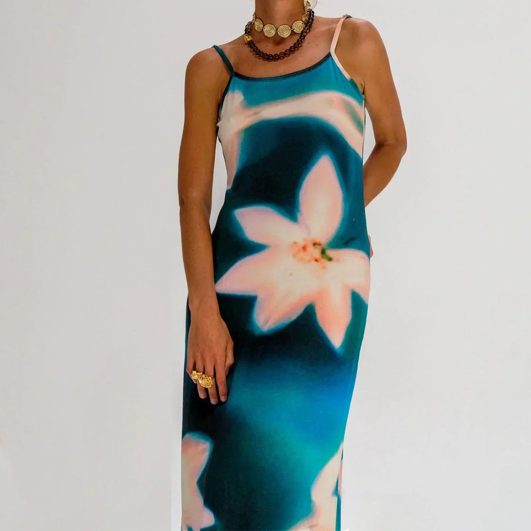 "Robe longue en tissu léger avec motifs artistiques colorés et bretelles fines pour un look élégant et décontracté."
