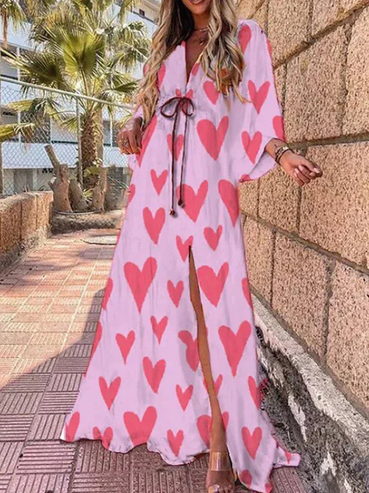 Robe longue rose à motifs, ceinture à la taille, manches longues, tissu léger et fluide, parfaite pour les occasions…