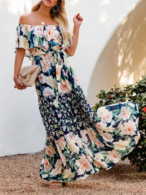 Robe longue femme en tissu léger, à épaules dénudées, ornée de motifs floraux colorés pour un style estival élégant.