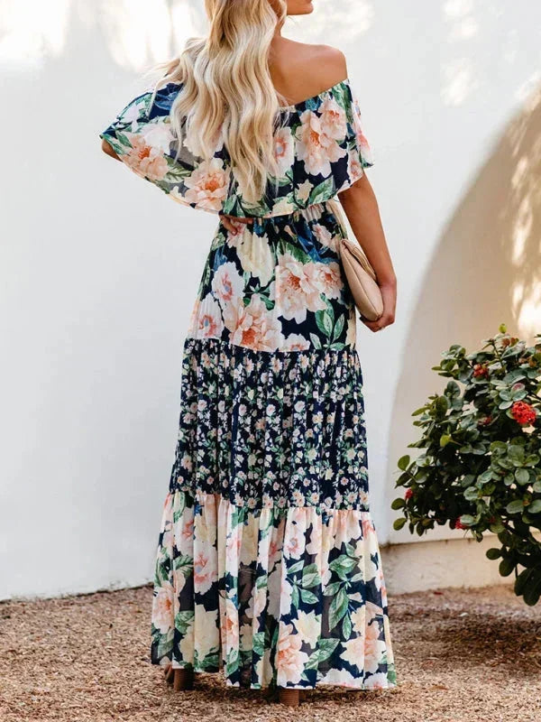 Robe longue femme à épaules dénudées, en tissu léger avec motifs floraux colorés pour un style décontracté et féminin.