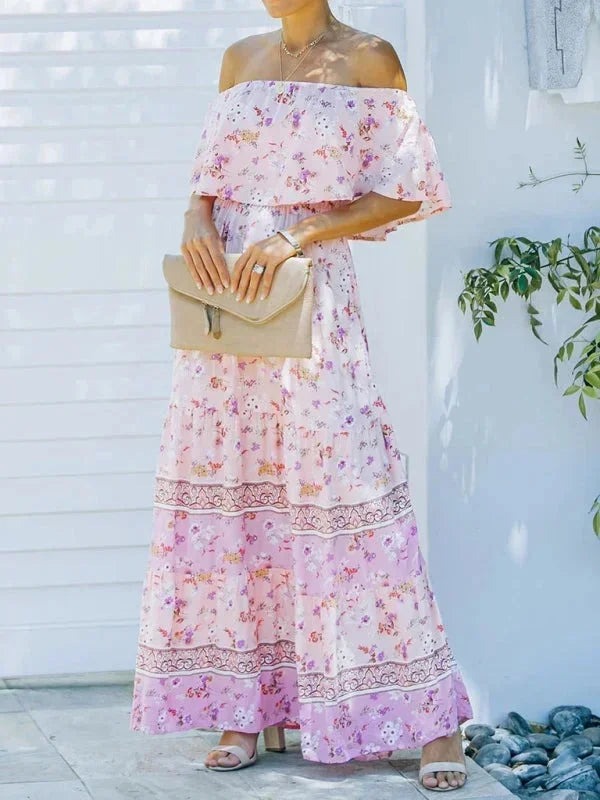 Robe longue femme à épaules dénudées, en tissu léger, avec motifs floraux colorés et taille ajustée.