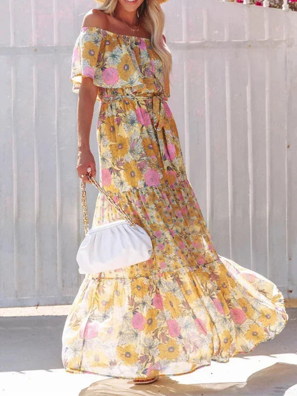 Robe longue à épaules dénudées en coton léger, ornée de motifs floraux colorés pour un style estival.