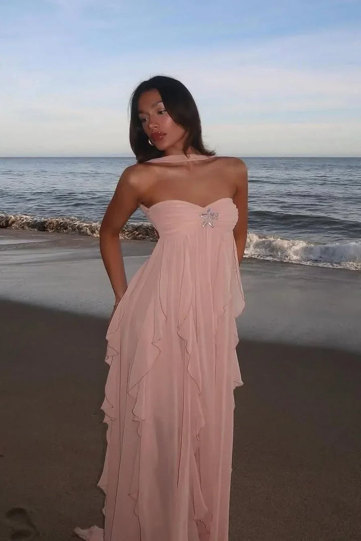 Robe longue rose femme en chiffon avec volants délicats et taille cintrée, idéale pour un look élégant.