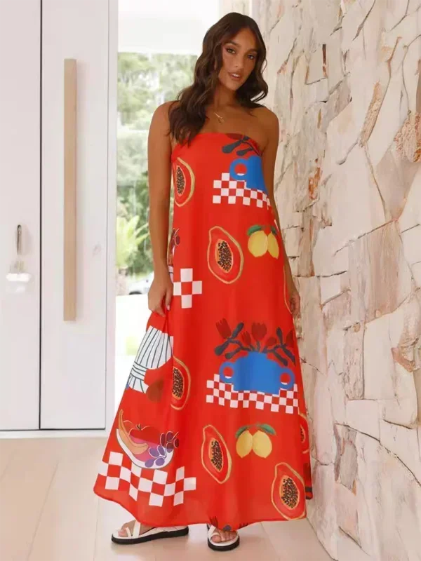 Robe longue sans bretelles, en coton léger, avec motifs estivaux colorés et volants à la taille pour un style décontracté.