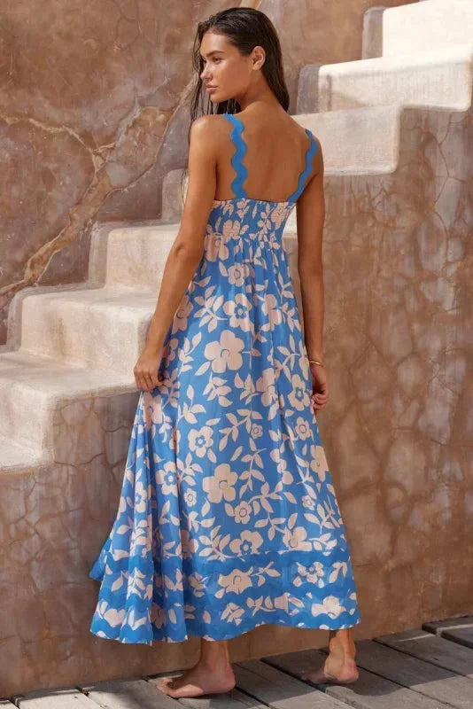 Robe longue femme sans manches en tissu léger avec un bord ondulé élégant et un motif floral discret.