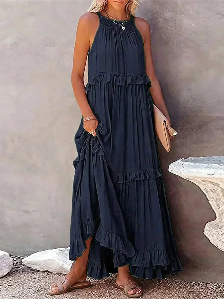 Robe longue femme sans manches bleu marine, en tissu léger, avec volants superposés pour une silhouette fluide et élégante.