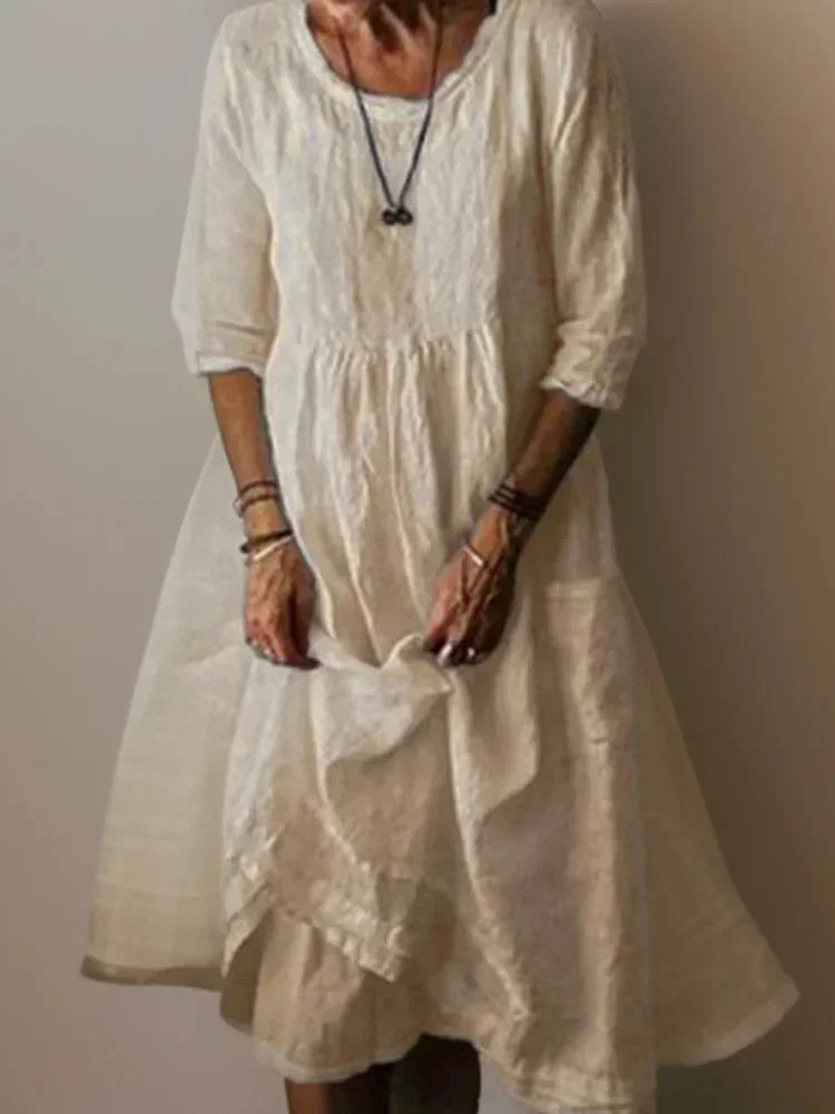 Robe longue beige femme à volants, col en V, manches 3/4, en tissu léger pour un confort optimal.