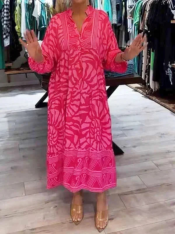 Robe longue fluide en rose, imprimée avec manches longues et col en V, en tissu léger et confortable pour un port agréable.