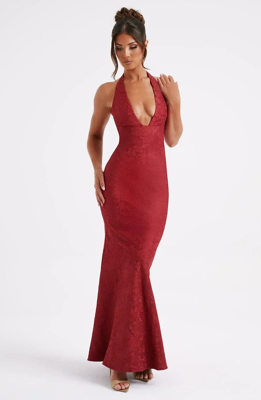 Robe longue rouge en tissu fluide, col licou élégant, et nœud élégant à la taille pour un look chic lors des soirées.