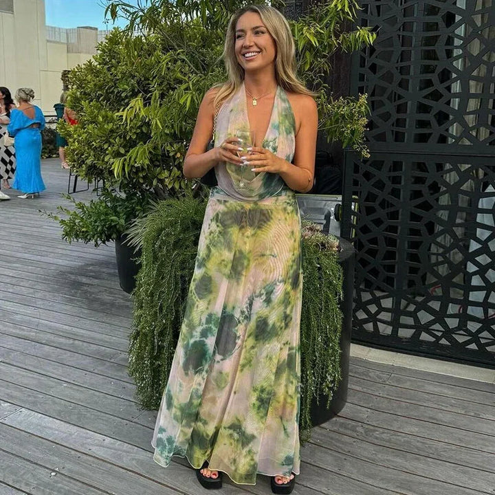 Robe longue dos nu tie-dye verte et rose en coton léger, avec col halter et un design fluides parfait pour l'été.
