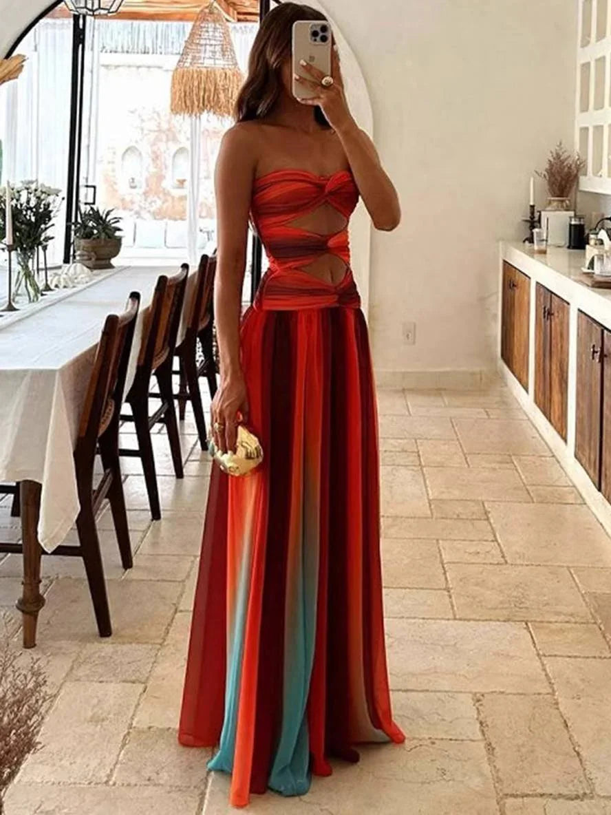 Robe maxi femme dégradé orange, en tissu léger, avec un dos nu élégant et des bretelles fines pour une silhouette féminine.