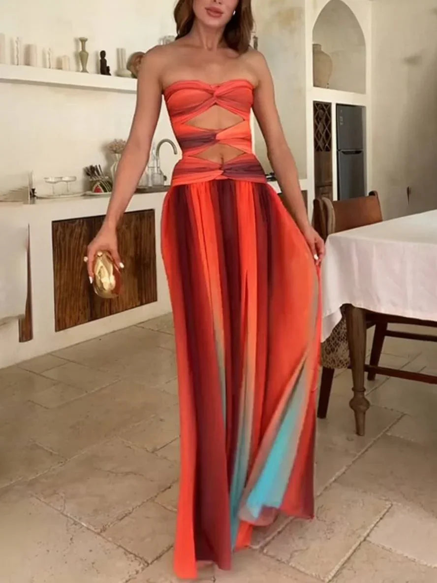Robe maxi femme en tissu léger, dégradé orange avec dos nu et design fluide, idéale pour les événements estivaux.
