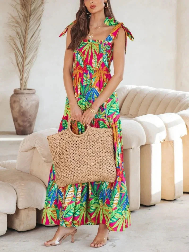 Robe longue femme sans manches en tissu léger, imprimé tropical avec nœuds aux épaules, idéale pour l'été.