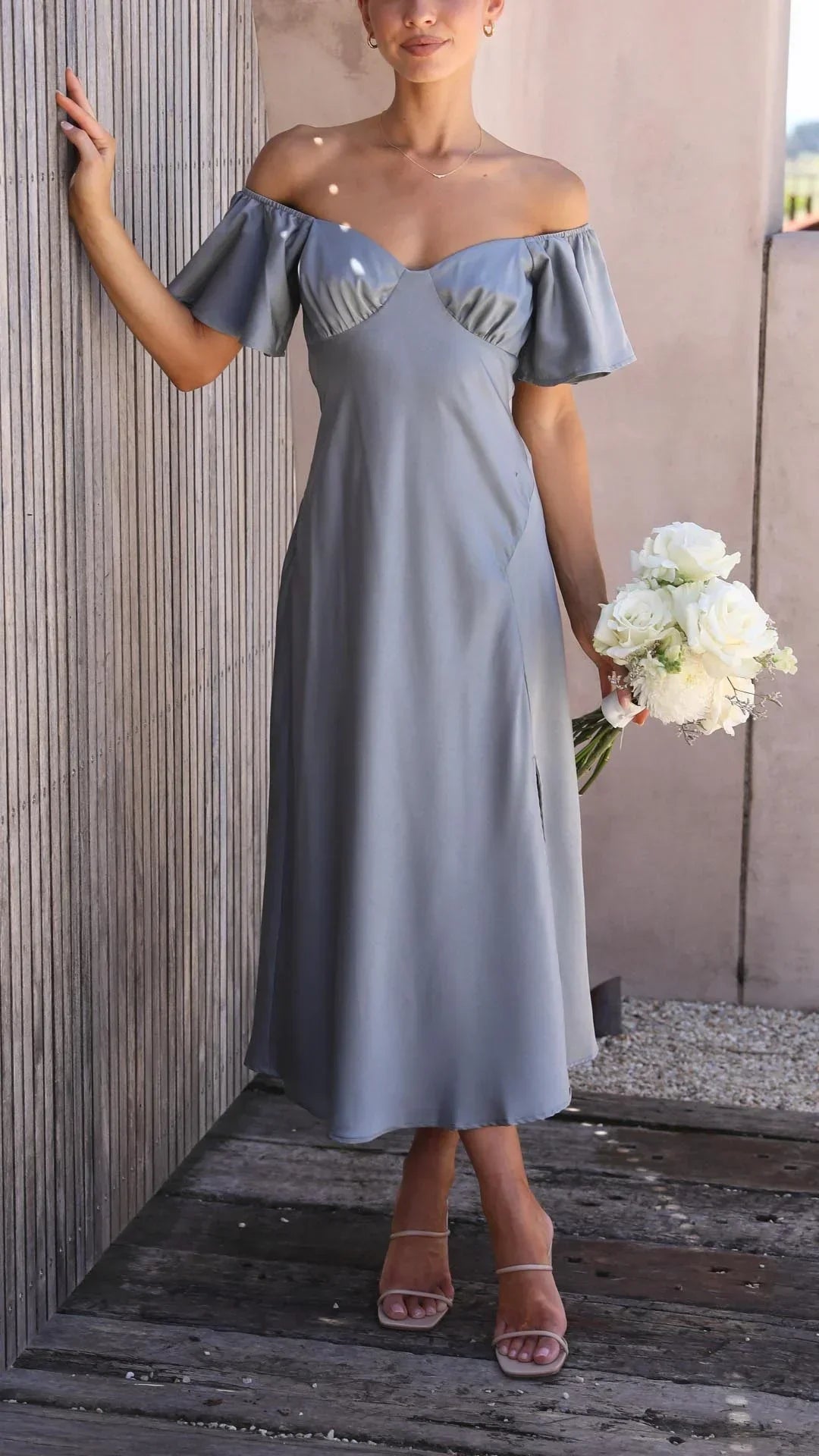 Robe longue fluide avec fente et épaules dénudées, idéale pour les soirées d'été et confectionnée dans un tissu léger.