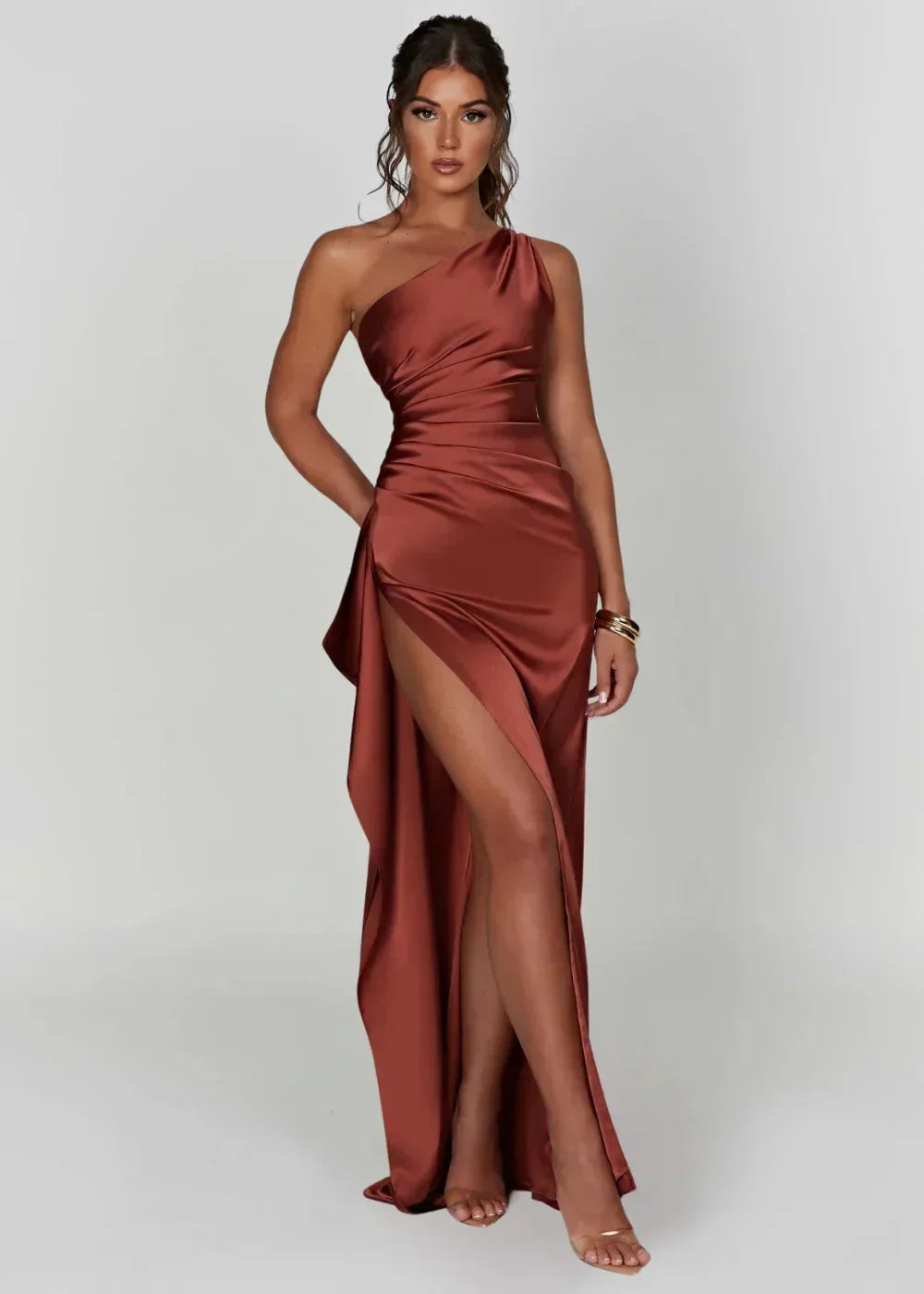 Robe maxi fendue à une épaule en tissu cuivré, légère et fluide, avec une fente pour une silhouette élégante.